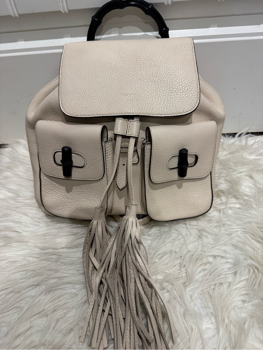Gucci Cream Pebbled Leather Backpack with Tassel Accents